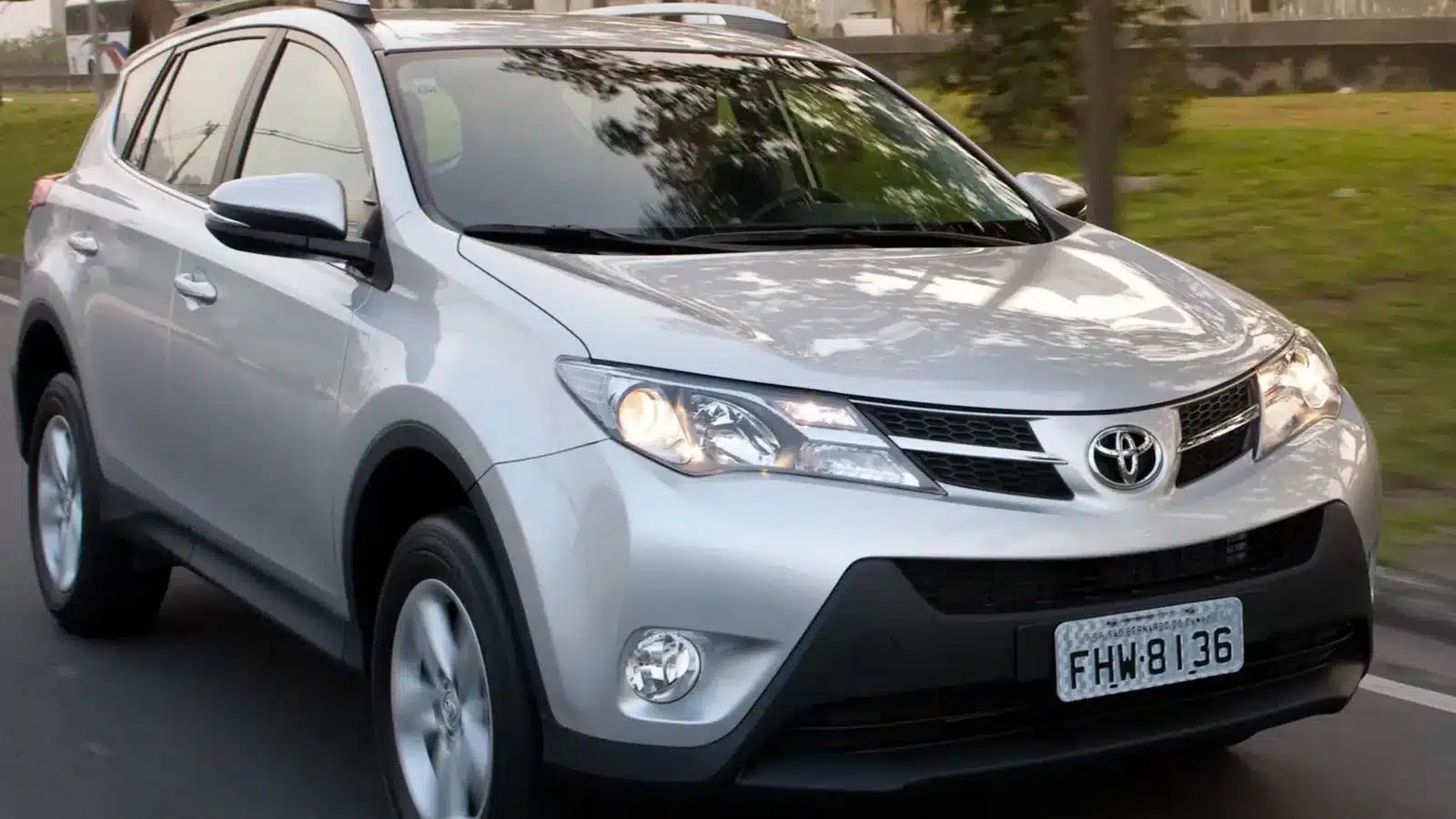 A silver Toyota RAV4 cruising on the road, highlighting its dependable performance and popular choice among used SUVs.