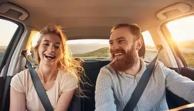 A couple riding home after closing a deal with the best car insurance in Georgia.