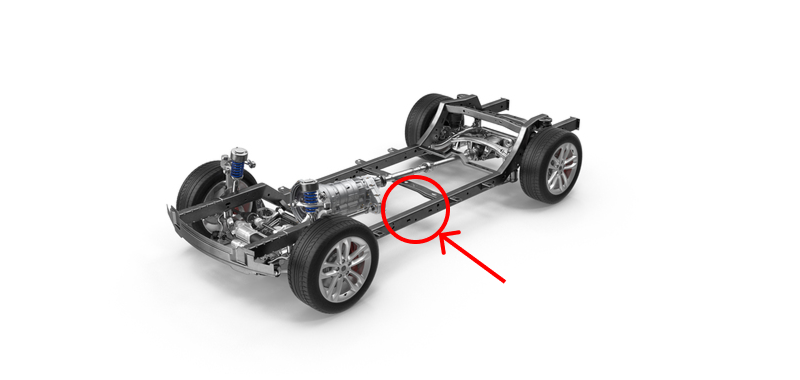 A image of a vehicle chassis with wheels, suspension, and drivetrain components, set against a white background. A red circle and arrow indicate a specific area of frame damage along the center rail of the chassis.