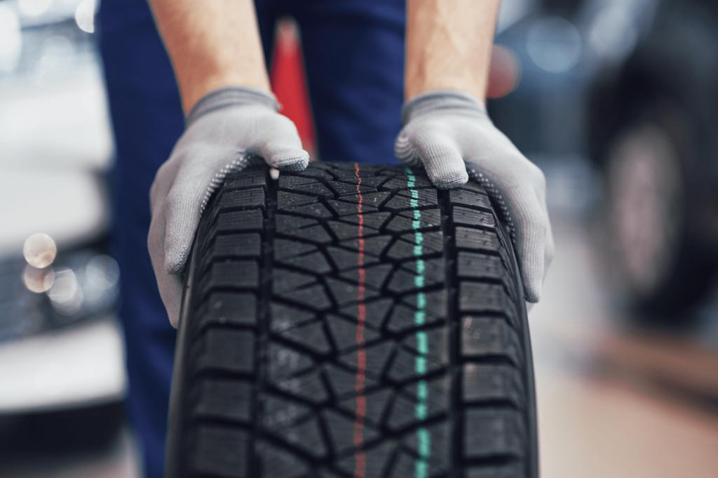 Men Pushing a black tire-min