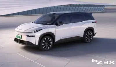 A modern white and black Toyota bZ3X electric SUV is parked outdoors. The vehicle has sleek lines, black roof, and distinctive front lighting, with "bZ3X" branding in the lower right corner.