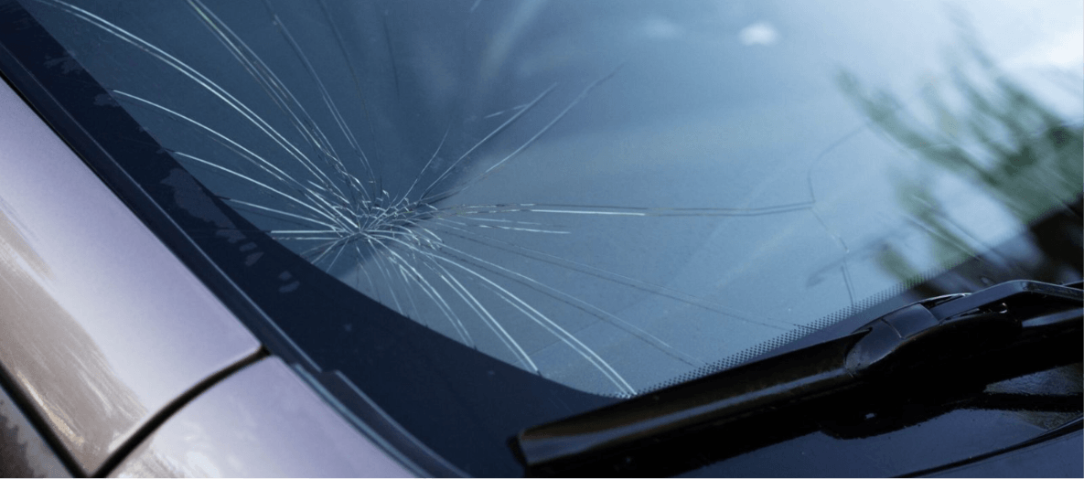 Close-Up of a Cracked Windshield with Spider Web Damage Pattern – Diminished Value of Georgia, Car Appraisals for Insurance Claims Close-up of a cracked windshield with spider web damage, showing why replacement may require ADAS camera calibration | Diminished Value of Georgia, Car Appraisals for Insurance Claims