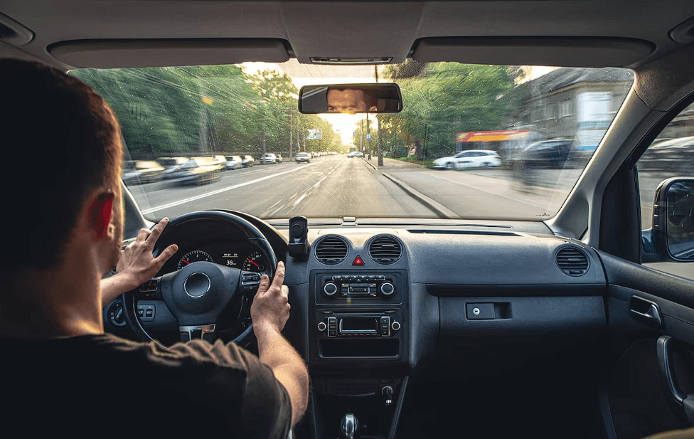 man driving car at high speed