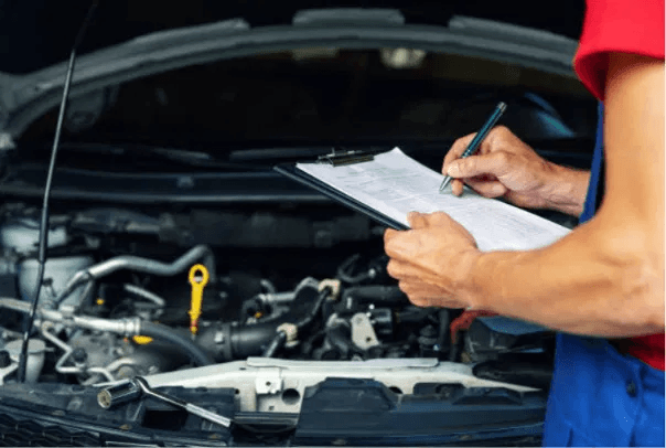 Vehicle Condition Inspection for a Georgia Diminished Value Claim – Diminished Value of Georgia, Car Appraisals for Insurance Claims Appraiser inspecting a vehicle engine bay with a checklist to document condition for a Georgia diminished value claim | Diminished Value of Georgia, Car Appraisals for Insurance Claims