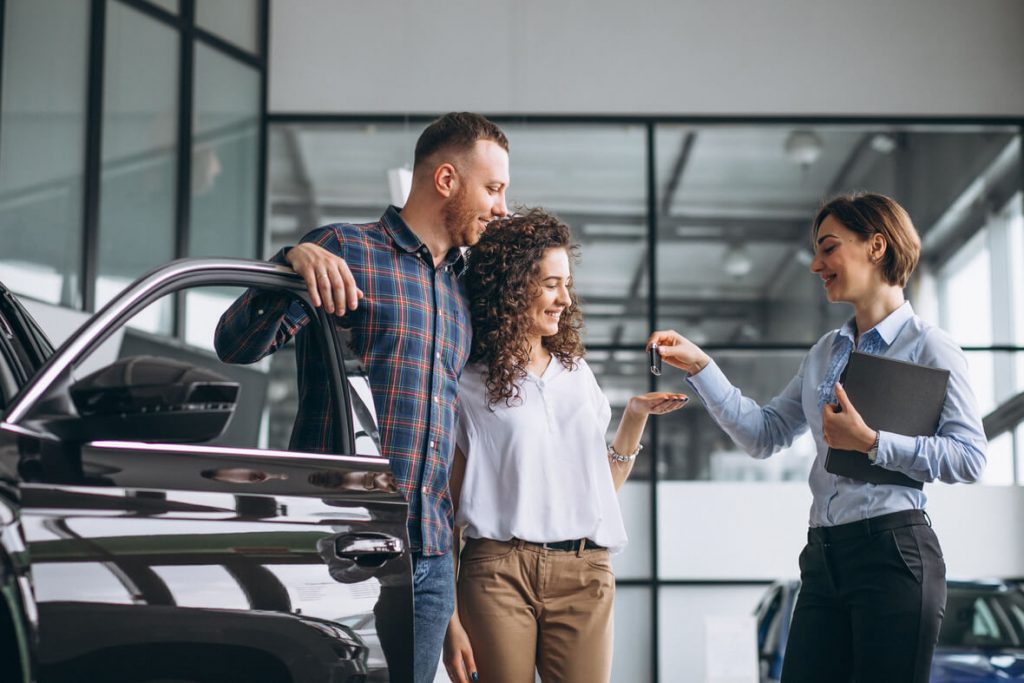 young-couple-choosing-car-car-show-room 1 1